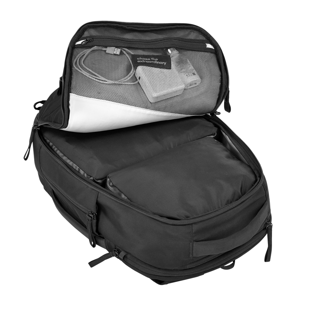 Black backpack with open front compartment showing electronic devices on a white background
