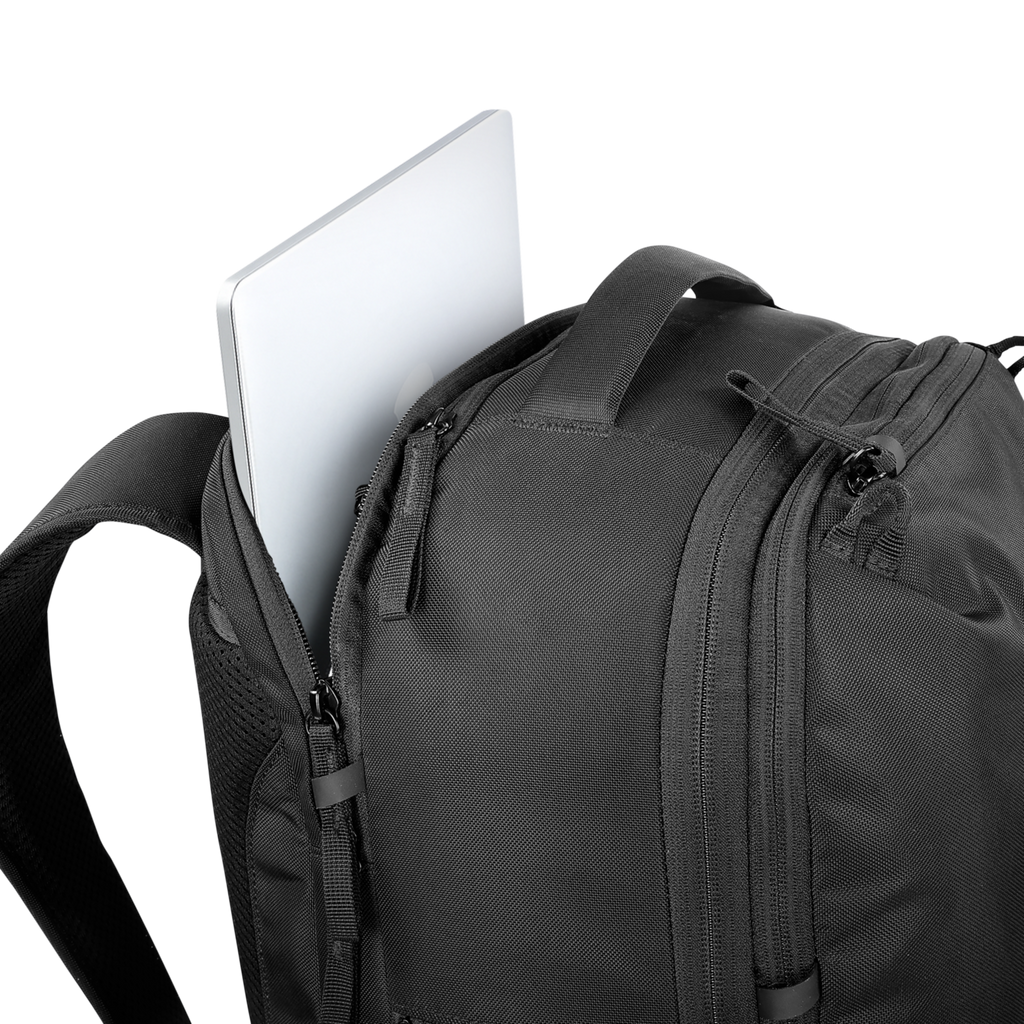 Black backpack with a laptop partially sticking out on a white background