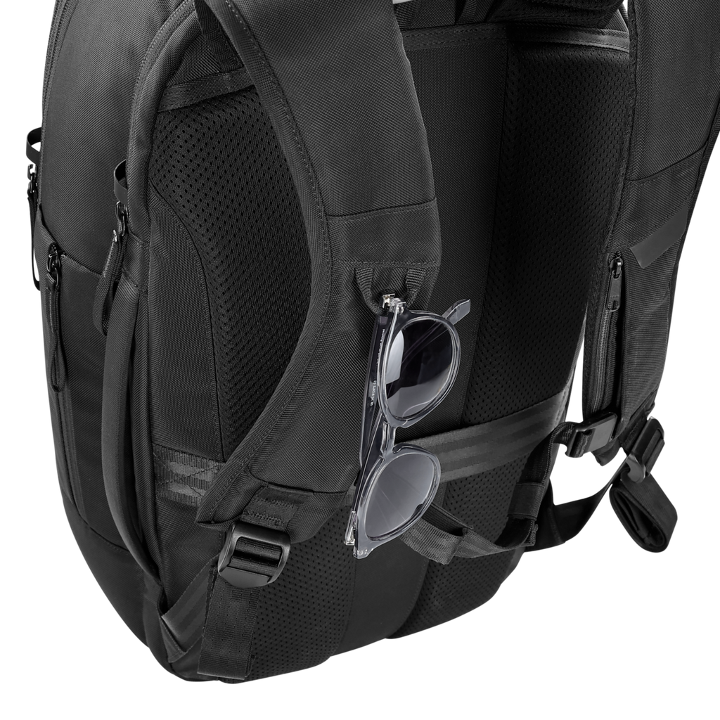 Black backpack with sunglasses hanging from a clip on a white background