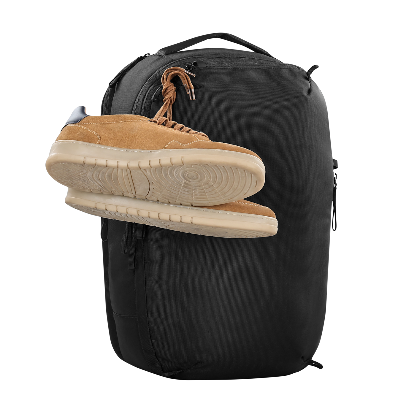 Black backpack with a tan sneaker on top against a white background