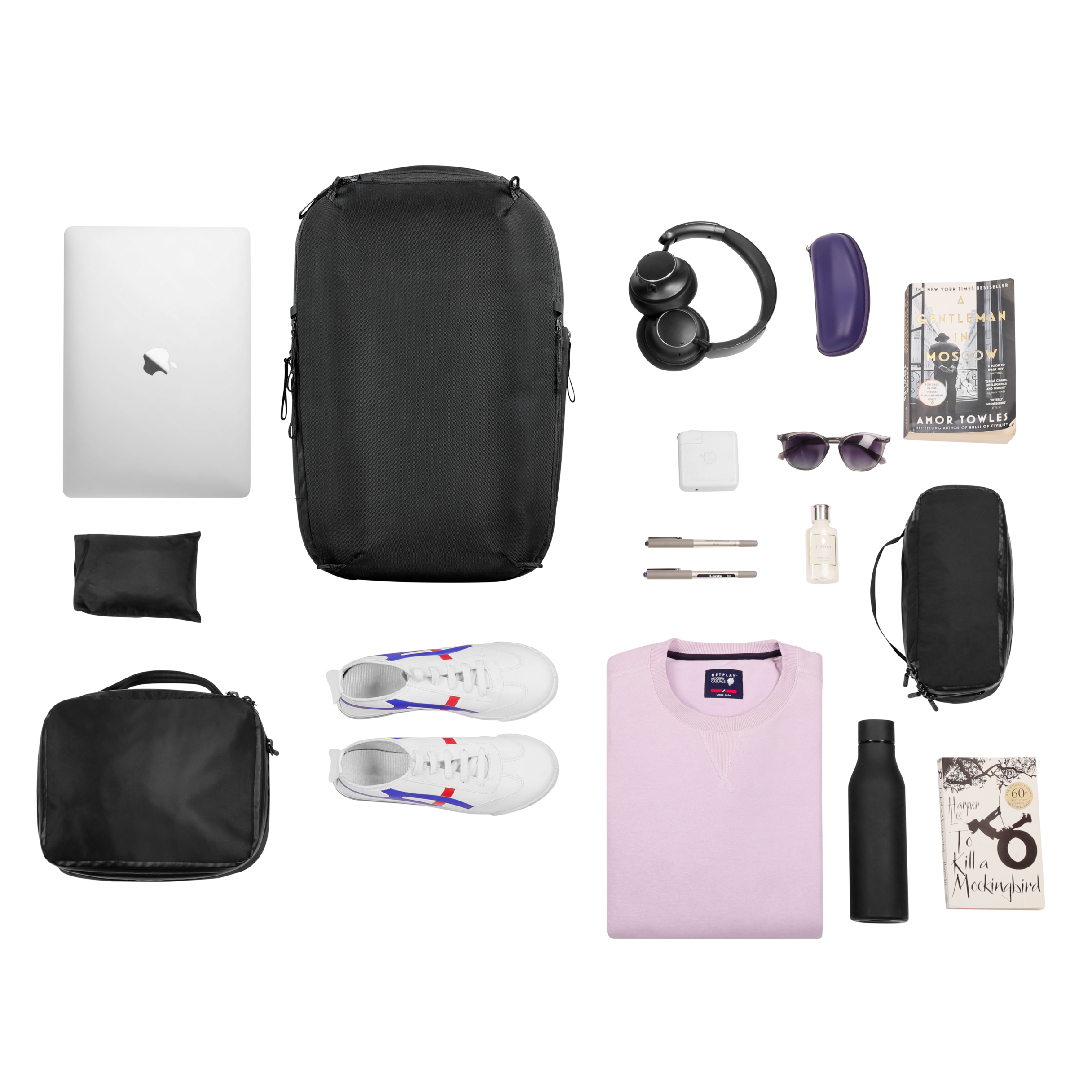 Collection of travel items including a backpack, shoes, and electronic devices on a white background