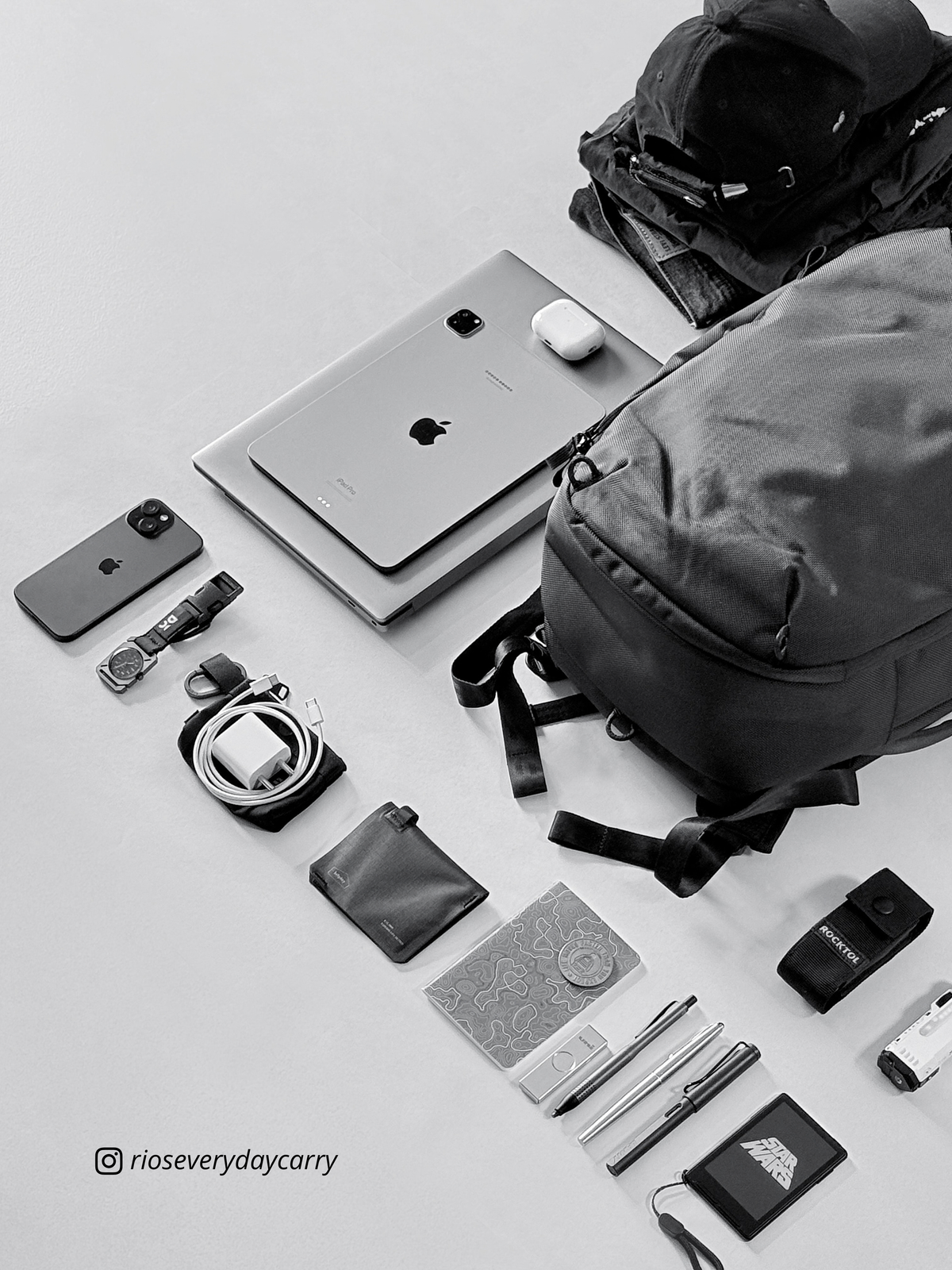 Black and white diagonal arrangement of Daily Dash, laptop, phones and accessories