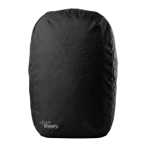 Black backpack with water droplets on a white background, featuring 'eleven theory' branding.